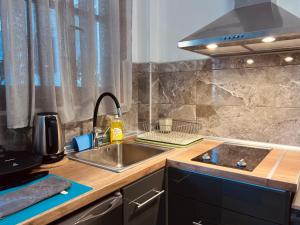 a kitchen with a sink and a stove at Yanna's Apartments in Sidari +249 photos