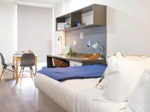 a bedroom with a bed and a desk and a table at For Students Only Market House in Newcastle in Newcastle upon Tyne