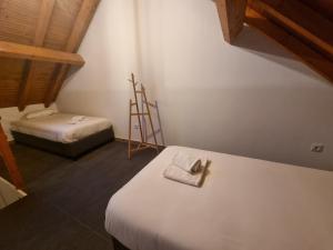 a small room with two beds and a ladder at G3 Gamboa Beach Houses in Peniche