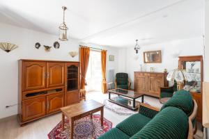 a living room with a couch and a table at Duplex Marjorie in Le Cheylard