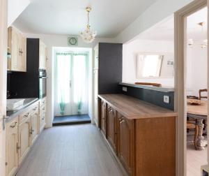 a kitchen with a large island in the middle at Duplex Marjorie in Le Cheylard