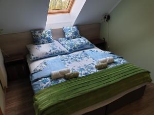 a bed with pillows on it in a bedroom at Gyula Villa in Hévíz