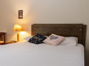 ein Schlafzimmer mit einem Bett mit zwei Kissen darauf in der Unterkunft Unidade do térreo: casa à beira mar XJ6722 in São Francisco do Sul