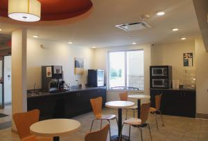 a restaurant with two tables and chairs and a counter at Motel 6-Mankato, MN in Mankato