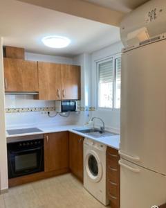 a kitchen with a white refrigerator and a dishwasher at Magnífico piso con vistas al mar en Moncofa in Moncófar +6 photos