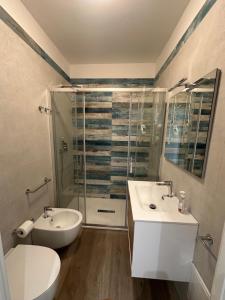 a bathroom with a sink and a toilet and a shower at Belvedere dagli oleandri in Liscia di Vacca