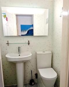 a bathroom with a sink and a toilet and a mirror at The Corner House - Charming Rustic Home in the Heart of Monchique in Monchique +29 photos