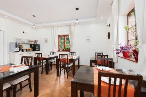 a dining room with wooden tables and chairs at Green lakes house 2 in Plitvička Jezera