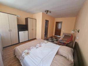 a bedroom with a bed with white sheets and flowers on it at Casa Sali in Turda