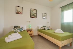 Postel nebo postele na pokoji v ubytování Casa Cactus