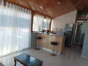 a kitchen with a table and two stools in it at Basma in Rafrāf