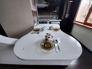 a white table with a plate on top of it at Уютная квартира , с удобствами in Taraz +5 photos