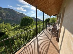 a balcony with chairs and a view of the mountains at Gnishik Eco Resort in Gnishik