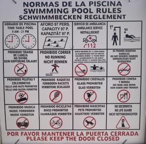 a bunch of signs that are on a wall at Ten-Beau Relax Bungalow in Maspalomas
