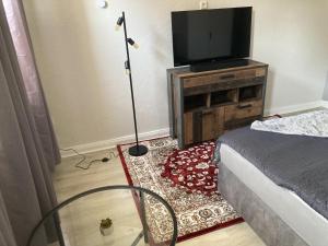 a bedroom with a bed and a television on a stand at Time-Out Westerbauer TC15B in Hagen +7 photos