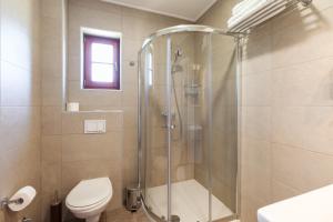 a bathroom with a shower and a toilet at Green lakes house 2 in Plitvička Jezera +37 photos
