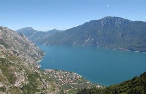 a large body of blue water between two mountains at Appartamento B&B Preone in Limone sul Garda +2 photos