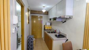 a small kitchen with a sink and a counter at Joyful studio unit in Davao City