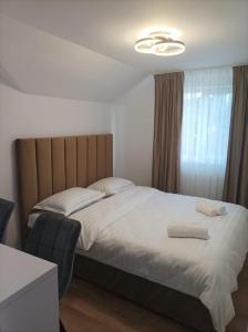 a bedroom with a large bed with white sheets at Casa Taramului in Turda