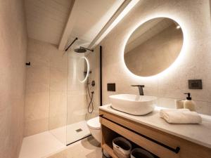 a bathroom with a sink and a toilet and a mirror at Topaz Rooms in Hvar
