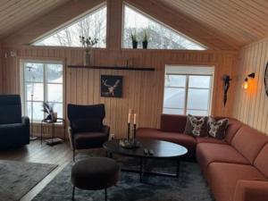 a living room with a couch and a table at Hytte Gaustablikk in Gaustablikk