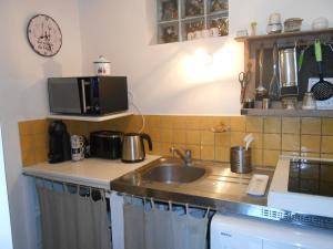 a kitchen with a sink and a microwave at Maison la ciotat in La Ciotat