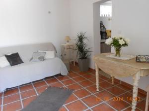 a bedroom with a bed and a table with flowers at Maison la ciotat in La Ciotat