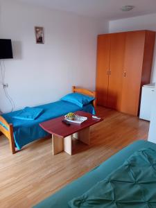 a living room with a table and a couch at Lebada Neagră in Schitul