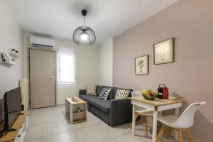 a living room with a couch and a table at City Center Apartment in Ioannina