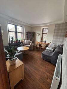 a living room with a couch and a table at My Alba Home in Fife
