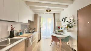 a kitchen with a small table and a sink at Merlo Holiday Room in Palermo