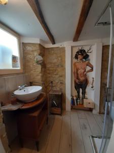 a bathroom with a sink and a painting on the wall at Oobeh Country House in Roncovetro +32 photos