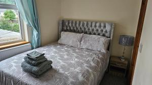 a bedroom with a bed with a backpack on it at The Apartment at Brook House in Llanberis
