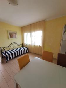 a living room with a couch and a table and chairs at Casa vacanza Gigi e Antonella in Porto Rotondo +51 photos