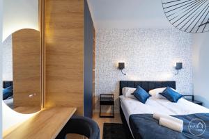 a bedroom with a bed and a wooden table at Picasso Apartment - Free Parking Place in Sosnowiec