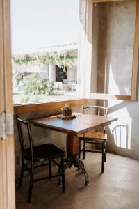 a wooden table and chairs in front of a window at Casa Mar in Prado +13 photos