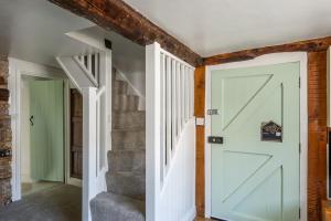 a hallway with a white door and stairs at Grade 2 Cottage 1 bedroom, Ludlow centre in Ludlow