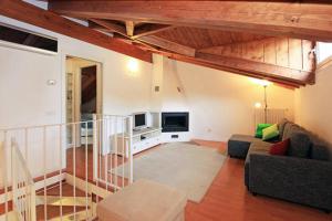 a living room with a couch and a tv at Navigli Downtown Cocco House in Milan