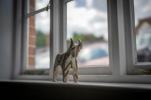 a small toy elephant sitting on a window sill at Grade 2 Cottage 1 bedroom, Ludlow centre in Ludlow