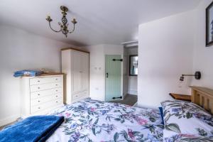 a bedroom with a bed and a dresser at Grade 2 Cottage 1 bedroom, Ludlow centre in Ludlow