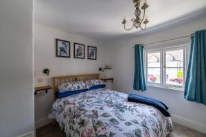 a bedroom with a bed and a window at Grade 2 Cottage 1 bedroom, Ludlow centre in Ludlow