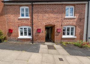 a brick building with a door and a doorway at Grade 2 Cottage 1 bedroom, Ludlow centre in Ludlow