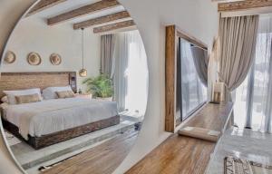 a bedroom with a large bed and a mirror at Le Sidi Cabana in El Alamein +38 photos