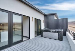 a wooden deck with glass doors and windows at Vizcaya #3 - Moab's Newest Luxury Rental - Private Hot Tub in Moab +5 photos