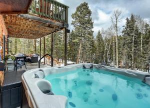 un bain à remous sur la terrasse d'une maison dans l'établissement Pinetop Cabin Hot Tub BBQ Arcade Scenic Escape, à Florissant