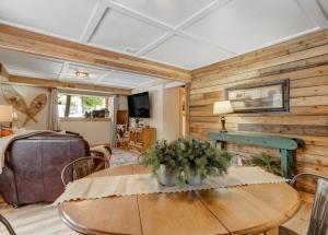 a living room with a table and a bedroom at Pinetop Cabin Hot Tub BBQ Arcade Scenic Escape in Florissant