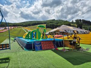 a water park with a bunch of slides and an umbrella at Woodpark Valčianska dolina in Valča