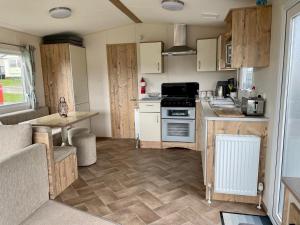 a small kitchen with a stove and a counter at 23 Kestrel quays in Flamborough