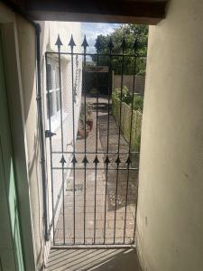 an iron gate with a view of a yard at Grade 2 Cottage 1 bedroom, Ludlow centre in Ludlow