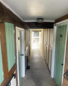 a hallway in a house with a hallway leading to a door at Grade 2 Cottage 1 bedroom, Ludlow centre in Ludlow